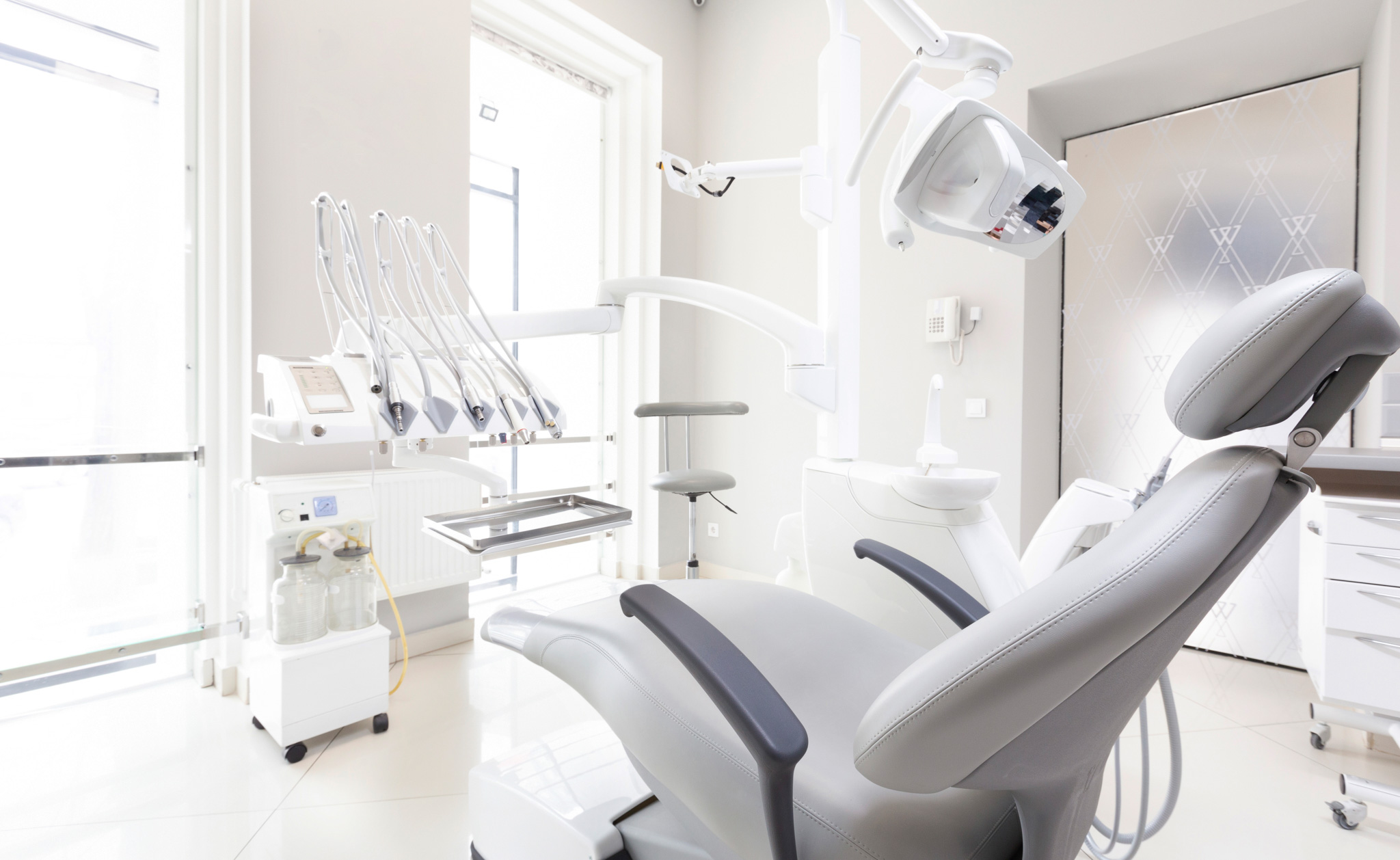 Dentist tools and professional dentistry chair in modern clinic